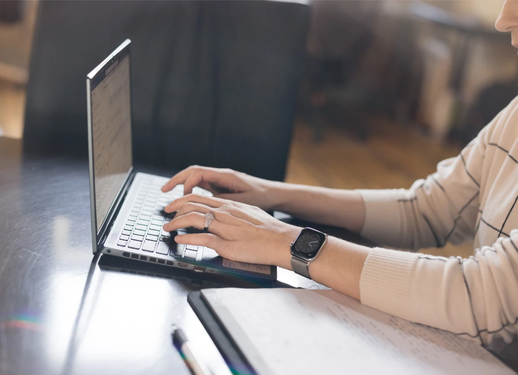 SEC Compliance consultant working on laptop reviewing materials