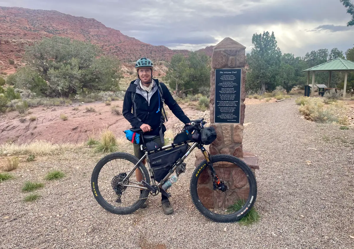 Brad standing next to Arizona trail marker