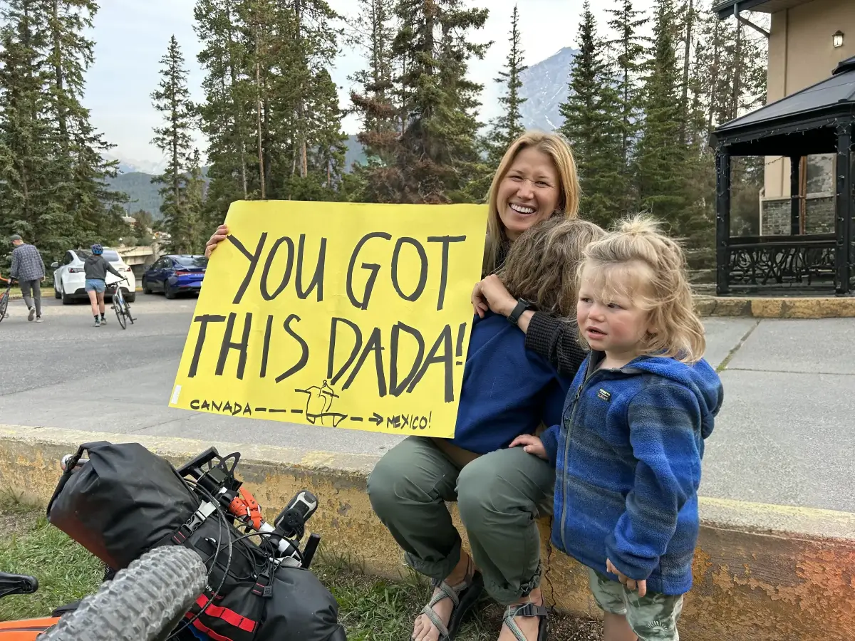Brad's family with holding sign with "You Got This Dadda" written on it.